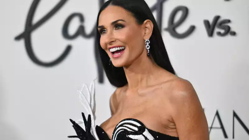 Demi Moore in a black and white Balmain swan dress for the premiere of "Feud: Capote vs.